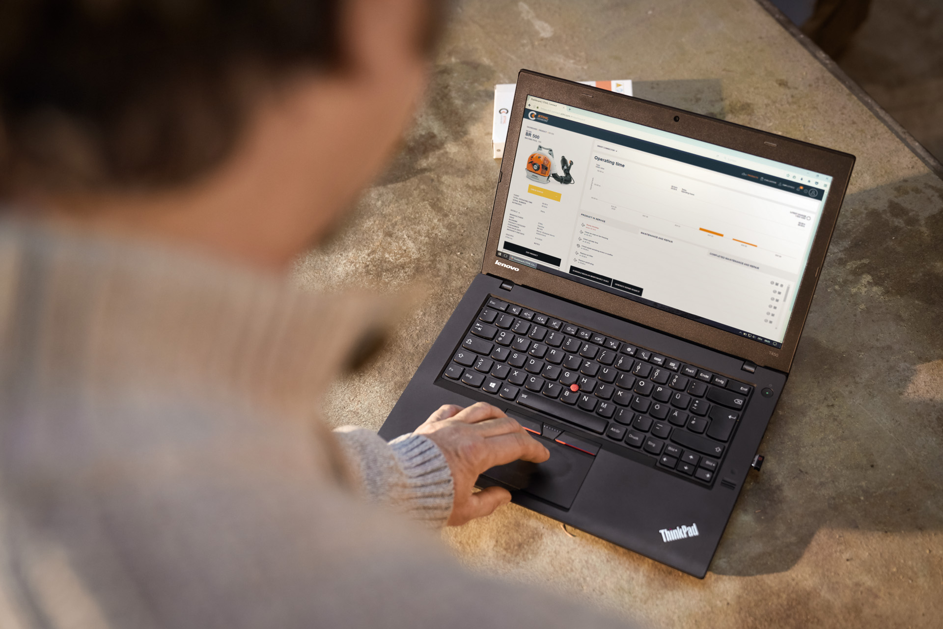 Person typing on a laptop using the STIHL Connected App